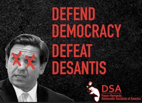 Picture of Ron DeSantis with his eyes crossed out. Picture reads: Defend
Democracy, Defeat DeSantis